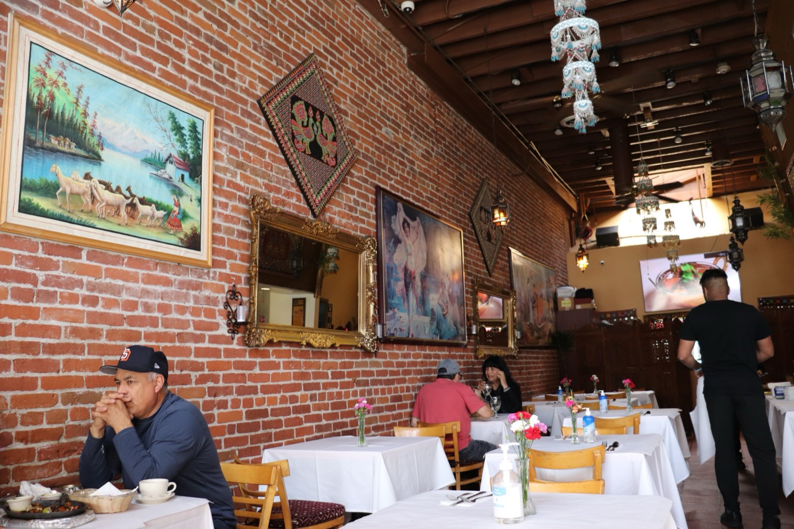 Warm brick dining room inside All India Cafe in Pasadena